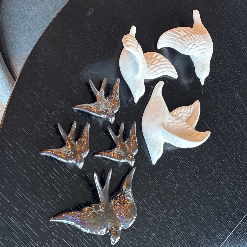 3 white and 4 dark, glossy birds for hanging on wall.